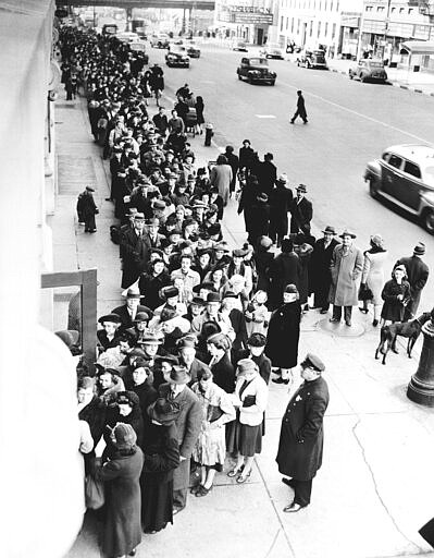 FILE - In this Feb. 23, 1943, file photo New Yorkers stand on long lines outside of schools all over the city to get their War Ration Book No. 2, during World War II. Not since World War II when people carried Ration Books with stamps that allowed them to purchase meat, sugar, butter, cooking oil and gasoline has the entire nation been asked to truly sacrifice for a greater good. (AP Photo, File)