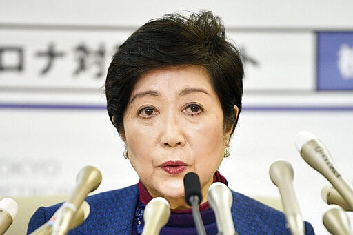 In this Wednesday, March 25, 2020, photo, Tokyo Gov. Yuriko Koike speaks during a press conference in Tokyo. Koike asked its residents on Wednesday to stay home this weekend to slow the spread of the new coronavirus. For most people, the new coronavirus causes mild or moderate symptoms, such as fever and cough that clear up in two to three weeks. For some, especially older adults and people with existing health problems, it can cause more severe illness, including pneumonia and death. (Tsuyoshi Ueda/Kyodo News via AP)