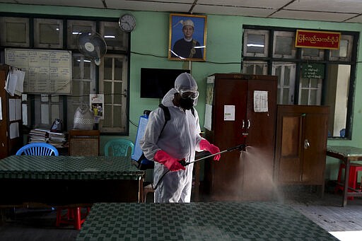 A member of the Yangon City and Development Committee disinfects government offices to help curb the spread of the new coronavirus in Yangon, Myanmar Wednesday, March 25, 2020. For most people, the new coronavirus causes mild or moderate symptoms, such as fever and cough that clear up in two to three weeks. For some, especially older adults and people with existing health problems, it can cause more severe illness, including pneumonia and death. (AP Photo/Thein Zaw)