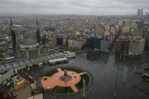 A view of the iconic Taksim Square in central Istanbul, deserted due to the coronavirus outbreak, Wednesday, March 25, 2020. The new coronavirus causes mild or moderate symptoms for most people, but for some, especially older adults and people with existing health problems, it can cause more severe illness or death.(AP Photo/Emrah Gurel)