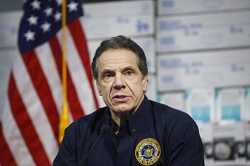 New York Gov. Andrew Cuomo speaks during a news conference against a backdrop of medical supplies at the Jacob Javits Center that will house a temporary hospital in response to the COVID-19 outbreak, Tuesday, March 24, 2020, in New York. Cuomo sounded his most dire warning yet about the coronavirus pandemic, saying the infection rate in New York is accelerating and the state could be as close as two weeks away from a crisis. (AP Photo/John Minchillo)