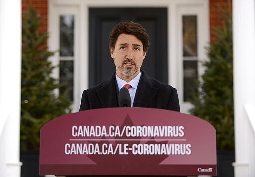 Canada's Prime Minister Justin Trudeau addresses Canadians on the coronavirus situation from Rideau Cottage in Ottawa, Ontario, on Wednesday, March 25, 2020. (Sean Kilpatrick/The Canadian Press via AP)