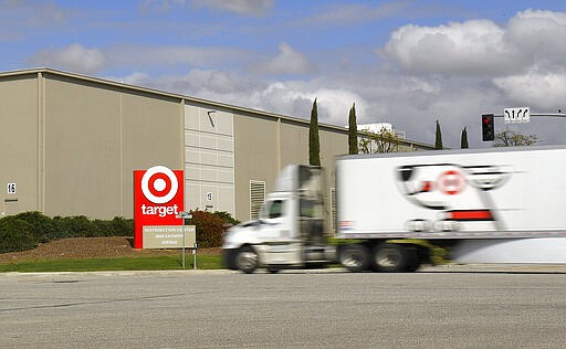 A semi truck drives toward a Target distribution center, Tuesday, March 24, 2020, in Shafter, Calif. (AP Photo/Mark J. Terrill)