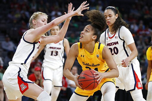 FILE - In this Friday, March 6, 2020, file photo, California's Evelien Lutje Schipholt (24) shoots against Arizona's Cate Reese, left, during the first half of an NCAA college basketball game in the quarterfinal round of the Pac-12 women's tournament in Las Vegas. Lutje Schipholt, from The Netherlands, is one of more than 20,000 foreign athletes currently competing at NCAA schools, according to the organization. With competition canceled across all NCAA divisions because of the new coronavirus, many of those athletes face a dilemma. Their campuses are shut down, but the coronavirus situation in their homeland may be worse than it is in the United States. (AP Photo/John Locher, File)