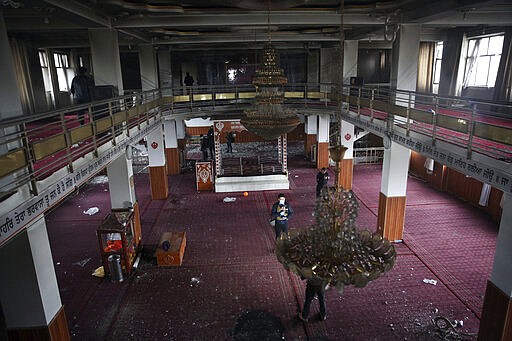 Afghan Journalists film inside a Sikh house of worship, called Gurdwara, after an attack in Kabul, Afghanistan, Wednesday, March 25, 2020. The Interior Ministry said a lone Islamic State gunman rampaged through the Sikh place of worship, in the heart of the Afghan capital on Wednesday, killing over 20 worshippers and wounding others. It says that the gunman held many of the worshippers hostage for several hours as Afghan special forces, helped by international troops, tried to clear the building. (AP Photo/Rahmat Gul)