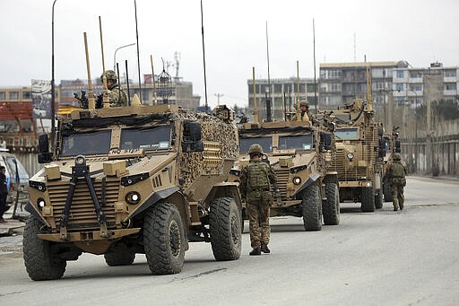 British soldiers with NATO-led Resolute Support Mission forces arrive at the site of an attack in Kabul, Afghanistan, Wednesday, March 25, 2020. Gunmen stormed a religious gathering of Afghanistan's minority Sikhs in their place of worship in the heart of the Afghan capital's old city on Wednesday, a minority Sikh parliamentarian said. (AP Photo/Rahmat Gul)