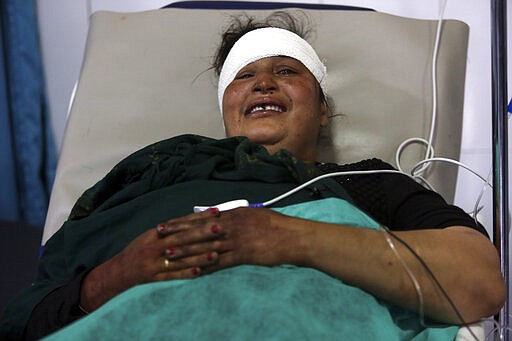 An Afghan Sikh woman wounded in a gunmen attack lies in a hospital in Kabul, Afghanistan, Wednesday, March 25, 2020. Gunmen stormed a religious gathering of Afghanistan's minority Sikhs in their place of worship in the heart of the Afghan capital's old city on Wednesday, a minority Sikh parliamentarian said. (AP Photo/Tamana Sarwary)