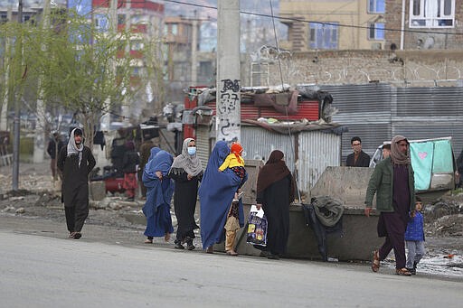 Afghan families leave the site of an attack in Kabul, Afghanistan, Wednesday, March 25, 2020. Gunmen stormed a religious gathering of Afghanistan's minority Sikhs in their place of worship in the heart of the Afghan capital's old city on Wednesday, a minority Sikh parliamentarian said. (AP Photo/Rahmat Gul)