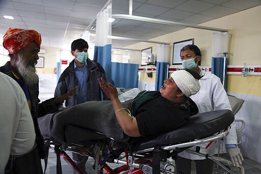 An Afghan Sikh woman wounded in a gunmen attack is brought to a hospital in Kabul, Afghanistan, Wednesday, March 25, 2020. Gunmen stormed a religious gathering of Afghanistan's minority Sikhs in their place of worship in the heart of the Afghan capital's old city on Wednesday, a minority Sikh parliamentarian said. (AP Photo/Tamana Sarwary)