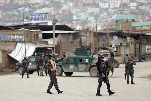 Security personnel arrive at the site of an attack in Kabul, Afghanistan, Wednesday, March 25, 2020. Gunmen stormed a religious gathering of Afghanistan's minority Sikhs in their place of worship in the heart of the Afghan capital's old city on Wednesday, a minority Sikh parliamentarian said. (AP Photo/Rahmat Gul)