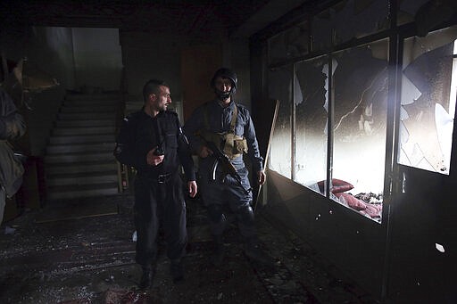 Afghan security personnel inspect a Sikh house of worship, in the aftermath of a deadly attack in Kabul, Afghanistan, Wednesday, March 25, 2020. The Interior Ministry said a lone Islamic State gunman rampaged through the Sikh place of worship, called Gurdwara, in the heart of the Afghan capital on Wednesday, killing over 20 worshippers and wounding others. It said that the gunman held many of the worshippers hostage for several hours as Afghan special forces, helped by international troops, tried to clear the building. (AP Photo/Rahmat Gul)