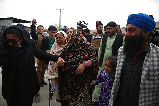 Family members cry after an attack in Kabul, Afghanistan, Wednesday, March 25, 2020. Gunmen stormed a religious gathering of Afghanistan's minority Sikhs in their place of worship in the heart of the Afghan capital's old city on Wednesday, a minority Sikh parliamentarian said. (AP Photo/Rahmat Gul)