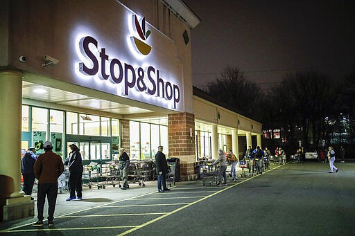 FILE - In this Friday, March 20, 2020 file photo, customers wait in line at a Stop &amp; Shop supermarket that opened special morning hours to serve people 60-years and older due to coronavirus concerns, in Teaneck, N.J. The outbreak of the coronavirus has dealt a shock to the global economy with unprecedented speed as it continues to spread across the world. Stop &amp; Shop will hire at least 5,000 new associates for regular part-time positions in its stores, distribution centers and delivery operations across New York, New Jersey, Connecticut, Massachusetts and Rhode Island.  (AP Photo/John Minchillo, File)