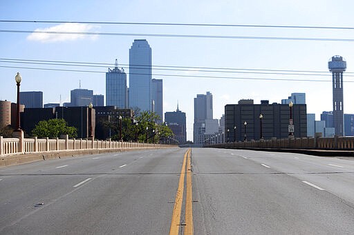 With Dallas County under a shelter in place order due to the COVID-19 disease, a normally busy road sits empty leading into downtown Dallas, Tuesday, March 24, 2020. Texas' lieutenant governor says the U.S. should get back to work in the face of the global pandemic and that people over the age of 70 will &quot;take care of ourselves.&quot; The Centers for Disease Control says people over the age of 65 are at higher risk from the coronavirus that causes the disease COVID-19. (AP Photo/LM Otero)