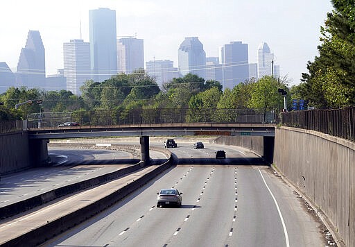 Traffic in and out of downtown Houston is lighter than normal Wednesday, March 25, 2020. A stay-at-home order was issued Tuesday for Houston and Harris County residents to help fight the spread of COVID-19. The new coronavirus causes mild or moderate symptoms for most people, but for some, especially older adults and people with existing health problems, it can cause more severe illness or death. (AP Photo/David J. Phillip)