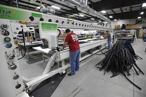 Workers make face shields at SugarHouse Industries Thursday, March 26, 2020, in Midvale, Utah. SugarHouse Industries, a Utah company that usually manufactures boat tops and covers, has reconfigured its operation amid the spread of the coronavirus to produce face shields and masks. (AP Photo/Rick Bowmer)