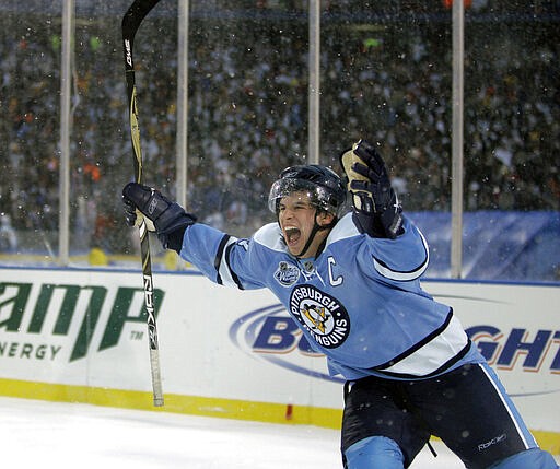 FILE - In this Jan. 1, 2008, file photo, Pittsburgh Penguins' Sidney Crosby celebrates his game winning shootout goal against the Buffalo Sabres during the NHL Winter Classic outdoor hockey game at Ralph Wilson Stadium in Orchard Park, N.Y. Hockey fans will have a chance to relive some of NBC's best NHL and Olympic games for the past 12 years next week during Hockey Week in America. (AP Photo/David Duprey, File)