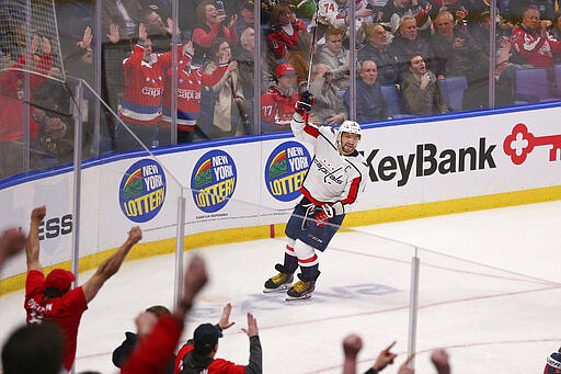 Washington Capitals forward Alex Ovechkin (8) celebrates a goal by teammate Dmitry Orlov during the third period of an NHL hockey game against the Buffalo Sabres, Monday, March 9, 2020, in Buffalo, N.Y. (AP Photo/Jeffrey T. Barnes)