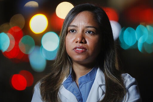 CORRECTS SPELLING TO DOOBAY INSTEAD OF DOOBEY ON SECOND REFERENCE - Kamini Doobay, an Emergency Medicine Resident physician at NYU Langone Medical Center and Bellevue Hospital, talks during an interview about her experiences treating COVID-19 patients, Thursday, March 26, 2020, in New York. As an emergency medicine physician in New York City, Dr. Doobay has always known that death is part of the territory in trying to care for the city's sickest. But it hasn't been like this _ patients stricken with coronavirus, on ventilators, and no visitors allowed because of strict protocols to prevent its spread. (AP Photo/John Minchillo)