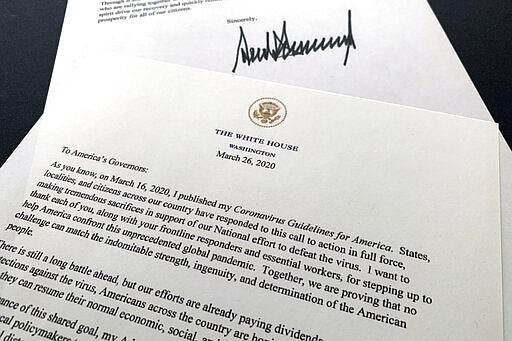 A letter from President Donald Trump to the nation's governors is photographed Thursday, March 26, 2020. Trump says that federal officials are developing guidelines to rate counties by risk of virus spread and that he wants to begin easing nationwide guidelines meant to stem the coronavirus outbreak. In the letter, Trump says the new guidelines are meant to enable state and local leaders to make &quot;decisions about maintaining, increasing, or relaxing social distancing and other measures they have put in place.&quot; (AP Photo/Jon Elswick)