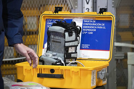 A ventilator is displayed during a news conference, Tuesday, March 24, 2020 at the New York City Emergency Management Warehouse, where 400 ventilators have arrived and will be distributed.  Gov. Andrew Cuomo has sounded his most dire warning about the coronavirus pandemic on Tuesday, saying the infection rate in New York is accelerating and the state could be two to three weeks away from a crisis.  (AP Photo/Mark Lennihan)