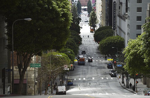 Traffic is light on Grand Avenue in downtown Los Angeles as stay-at-home orders due to coronavirus continue in the city, Wednesday, March 25, 2020. (AP Photo/Chris Pizzello)