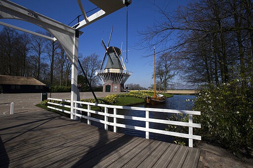 View of the empty world-renowned, Dutch flower garden Keukenhof which was closed because of the coronavirus, in Lisse, Netherlands, Thursday, March 26, 2020. Keukenhof, which attracted 1.5 million visitors last year, will not open after the Dutch government extended its ban on gatherings to June 1 in an attempt to slow the spread of the virus. Instead of opening, it will allow people to virtually visit its colorful floral displays through its social media and online channels. The new coronavirus causes mild or moderate symptoms for most people, but for some, especially older adults and people with existing health problems, it can cause more severe illness or death. (AP Photo/Peter Dejong)