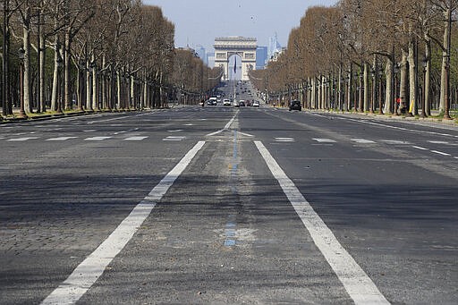 FILE - In this March 19 2020 file photo, the mostly empty Champs Elysees avenue is pictured in Paris, Thursday, March 19, 2020. The confinement measures in and around Paris have had an impact in reducing the French capital's noise pollution levels. The new coronavirus causes mild or moderate symptoms for most people, but for some, especially older adults and people with existing health problems, it can cause more severe illness or death. (AP Photo/Michel Euler)