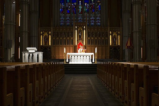 Cardinal Thomas Collins, the Catholic Archbishop of Toronto, performs a live-streamed mass at St. Michael's Cathedral in Toronto, on Wednesday March 25, 2020, after churches were closed due to the COVID-19 pandemic.(Chris Young/The Canadian Press via AP)