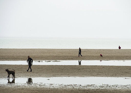 People practice social distancing during the coronavirus outbreak at Woodbine Beach in Toronto, Thursday, March 26, 2020. Health and government officials have repeatedly asked people to stay at home and to practice physical distancing to help stop the spread of the coronavirus also known as COVID-19. (Nathan Denette/The Canadian Press via AP)