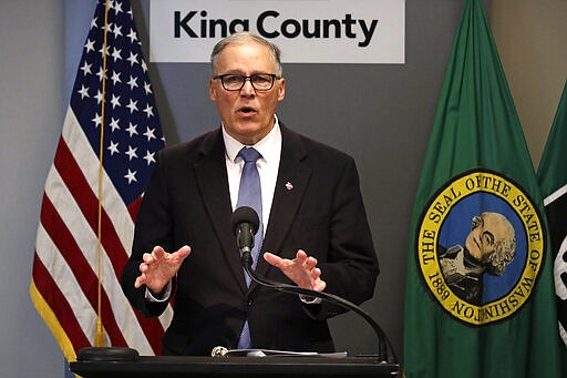 FILE - In this March 16, 2020, photo Washington Gov. Jay Inslee speaks about the coronavirus outbreak in Seattle. Inslee ordered all bars, restaurants, entertainment and recreation facilities to temporarily close to fight the spread of COVID-19 in the state with by far the most deaths in the U.S. from the disease. (AP Photo/Elaine Thompson, Pool)