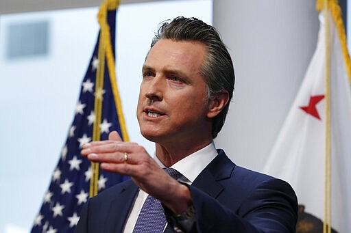 FILE - In this March 23, 2020, file photo California Gov. Gavin Newsom updates the state's response to the coronavirus, at the Governor's Office of Emergency Services in Rancho Cordova, Calif. Amid an unprecedented public health crisis, the nation&#146;s governors are trying to get what they need from the federal government &#8211; and fast. But often that means navigating the disorienting politics of dealing with President Donald Trump. (AP Photo/Rich Pedroncelli, File)