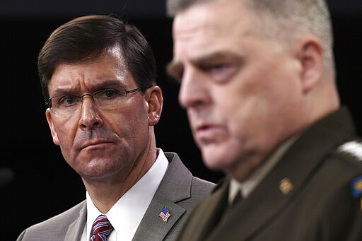 Defense Secretary Mark Esper, left, listens as Chairman of the Joint Chiefs of Staff Army Gen. Mark Milley, right, speaks during a briefing at the Pentagon in Washington, Monday, March 2, 2020. (AP Photo/Susan Walsh)