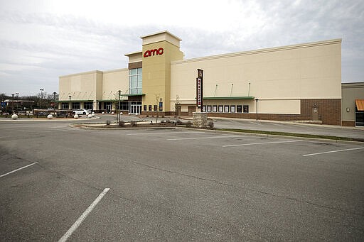 In this Tuesday, March 24, 2020 photo, movie theater is closed at Anderson Towne Center in Anderson Township, Ohio, on the first day of Ohio Gov. Mike DeWine's shelter-in-place order in response to the new coronavirus pandemic. All non-essential businesses are closed and residents have been asked to stay at home. (Kareem Elgazzar/The Cincinnati Enquirer via AP)