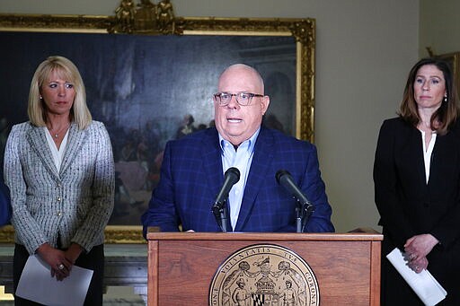 Maryland Gov. Larry Hogan, who chairs the National Governors Association, talks about initiatives and funding Maryland is making available to help small businesses and employees hurt by the coronavirus' impact on the economy during a news conference in Annapolis, Md., on Monday, March 23, 2020. Hogan also discussed plans to ask the federal government for more direct financial aid to the states in a conference call Monday with the White House. Kelly Schulz, the secretary of the Maryland Department of Commerce is standing left, and Tiffany Robinson, secretary of the Maryland Department of Labor, Licensing and Regulation, is standing right. (AP Photo/Brian Witte)