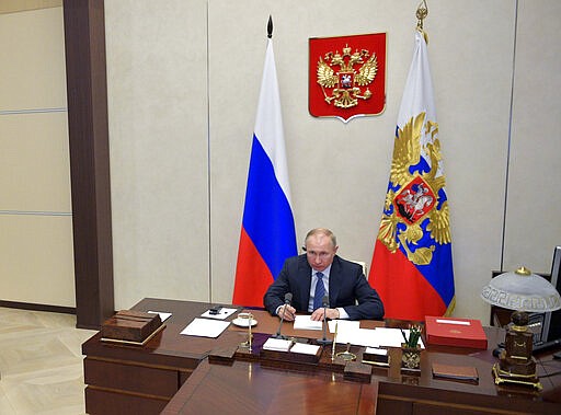 Russian President Vladimir Putin attends a videoconference with G20 leaders to discuss the coronavirus disease outbreak, at the Novo-Ogaryovo residence outside Moscow, Russia, Thursday, March 26, 2020. Leaders of the world's most powerful economies will convene virtually to coordinate a response to the fast-spreading new coronavirus. The new coronavirus causes mild or moderate symptoms for most people, but for some, especially older adults and people with existing health problems, it can cause more severe illness or death. (Alexei Druzhinin, Sputnik, Kremlin Pool Photo via AP)