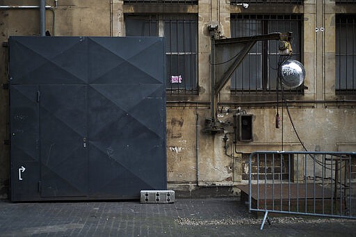 In this March 25, 2020, photo, an entrance to music club Alte Muenze is locked in Berlin, Germany. The nightclubs in the German capital have decided to keep the beat going &#151; at least online. Berlin's nightclubs were closed on March 13 in an attempt to slow the spread of the coronavirus. In response, some clubs formed a streaming platform to let DJs, musicians and artists continue to perform. (AP Photo/Markus Schreiber)