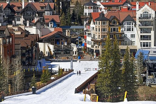 In this Tuesday, March 24, 2020, photo it is mostly deserted after the Vail Ski Resort closed for the season amid the COVID-19 pandemic, in Vail, Colo. Ski resorts across the West that were shut down amid coronavirus fears are grappling with an economic &#147;body blow&quot; at a time when they normally would be welcoming hoards of spring break revelers. (AP Photo/Michael Ciaglo)