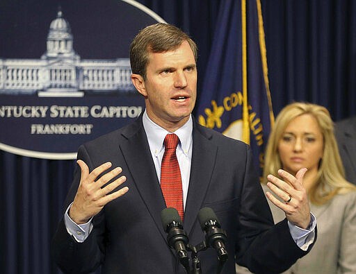 In this Tuesday, March 9, 2020 photo, Kentucky Gov. Andy Beshear speaks at a press conference on the coronavirus and Kentucky's steps to combat the outbreak at the capitol in Frankfort, Ky. Kentucky has reported its first death linked to coronavirus. Beshear said Monday, March 16 that the 66-year-old Bourbon County man who died had other health conditions.  (Michael Clevenger/Courier Journal via AP)