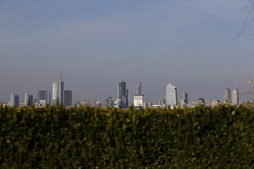 In this photo taken on Wednesday, Oct. 25, 2017, the skyline seen from the roof of Martini Terrace, in Milan, Italy. The eurozone's third-largest economy and a major exporter, Italy on Wednesday becomes the first western industrialized nation to idle swaths of industrial production to stop the spread of coronavirus by keeping yet more of the population at home. The new coronavirus causes mild or moderate symptoms for most people, but for some, especially older adults and people with existing health problems, it can cause more severe illness or death. (AP Photo/Luca Bruno, File)