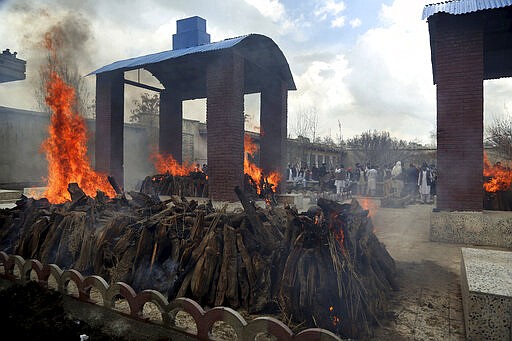 Afghan Sikh men attend a funeral procession and cremation ceremony for those who were killed on Wednesday by a lone Islamic State gunman, rampaged through a Sikh house of worship, in Kabul, Afghanistan, Thursday, March 26, 2020. An explosive device disrupted Thursday's funeral service for 25 members of Afghanistan's Sikh minority community, killed in an attack by the Islamic State group on their house of worship in the heart of the capital. (AP Photo/Tamana Sarwary)