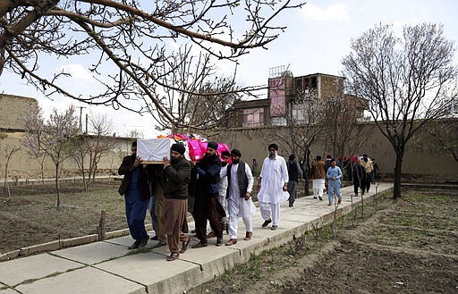 Afghan Sikh men carry coffins of their beloved ones during a funeral procession for those who were killed on Wednesday by a lone Islamic State gunman, rampaged through a Sikh house of worship, in Kabul, Afghanistan, Thursday, March 26, 2020. An explosive device disrupted Thursday's funeral service for 25 members of Afghanistan's Sikh minority community, killed in an attack by the Islamic State group on their house of worship in the heart of the capital. (AP Photo/Tamana Sarwary)