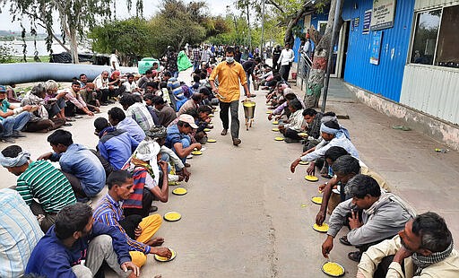 Homeless and impoverished Indians receive food at a government shelter in New Delhi, India, Thursday, March 26, 2020. Some of India's legions of poor and people suddenly thrown out of work by a nationwide stay-at-home order began receiving aid distribution Thursday, as both the public and private sector work to blunt the impact of efforts to curb the coronavirus pandemic. (AP Photo)