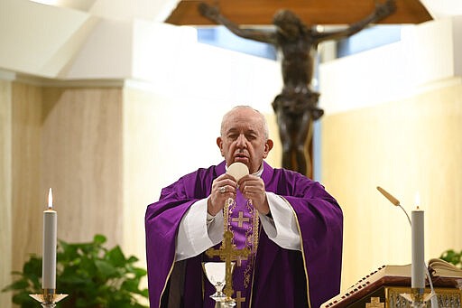 Pope Francis celebrates Mass at his Santa Marta residence, at the Vatican, Thursday, March 26, 2020. The new coronavirus causes mild or moderate symptoms for most people, but for some, especially older adults and people with existing health problems, it can cause more severe illness or death. (Vatican News via AP)