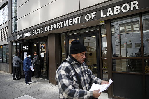 FILE - In this March 18, 2020 file photo, visitors to the Department of Labor are turned away at the door by personnel due to closures over coronavirus concerns in New York. A record-high number of people applied for unemployment benefits last week as layoffs engulfed the United States in the face of a near-total economic shutdown caused by the coronavirus. The surge in weekly applications for benefits far exceeded the previous record set in 1982.  (AP Photo/John Minchillo, File)