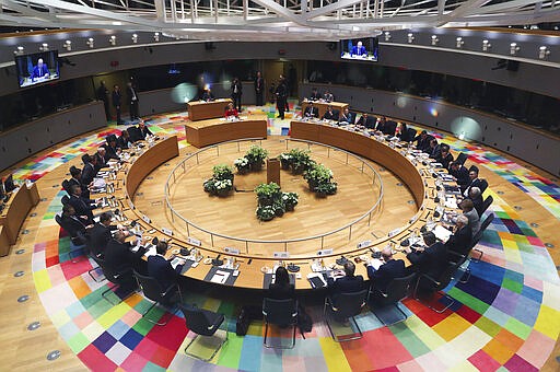 FILE - In this Feb. 21, 2020 file photo, European Union leaders meet at a round table during an EU summit in Brussels. European Union leaders are convening by video conference Thursday, March 26, 2020, for their third summit in three weeks, as they battle to contain the spread of the coronavirus. The new coronavirus causes mild or moderate symptoms for most people, but for some, especially older adults and people with existing health problems, it can cause more severe illness or death. (Yves Herman, Pool Photo via AP, File)