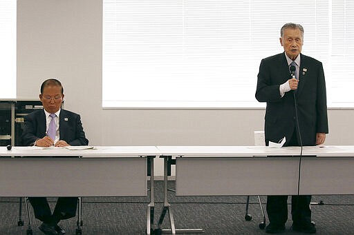 Tokyo 2020 Organizing Committee President Yoshiro Mori, right, speaks as CEO Toshiro Muto listens during the the first meeting of  the &#147;Tokyo 2020 New Launch Task Force&quot; in Tokyo, Thursday, March 26, 2020, two days after the unprecedented postponement was announced due to the spreading coronavirus. The new Tokyo Olympics need dates for the opening and closing ceremony in 2021. Nothing moves until this is worked out by the International Olympic Committee, the Japanese government, and Tokyo organizers. (AP Photo/Koji Sasahara)