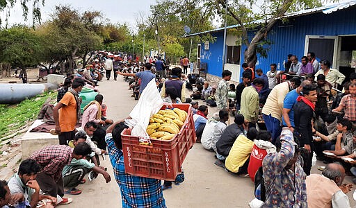 Homeless and impoverished Indians receive food at a government shelter in New Delhi, India, Thursday, March 26, 2020. Some of India's legions of poor and people suddenly thrown out of work by a nationwide stay-at-home order began receiving aid distribution Thursday, as both the public and private sector work to blunt the impact of efforts to curb the coronavirus pandemic. (AP Photo)