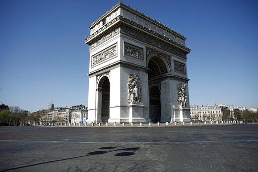 This picture shows the empty Arc of Triomphe square during a nationwide confinement to counter the new coronavirus, in Paris, Thursday, March 26, 2020. The new coronavirus causes mild or moderate symptoms for most people, but for some, especially older adults and people with existing health problems, it can cause more severe illness or death. (AP Photo/Thibault Camus)