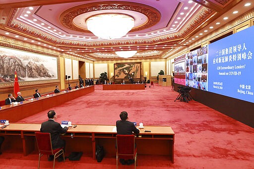 In this photo released by Xinhua News Agency, Chinese President Xi Jinping, fourth from left, attends the G20 Extraordinary Virtual Leaders' Summit on COVID-19 via video link in Beijing, capital of China, March 26, 2020. Leaders of the world's most powerful economies convened virtually on Thursday with the aim of coordinating a global response to the fast-spreading coronavirus, which has shuttered businesses and forced well over a quarter of the world's population into home isolation. (Pang Xinglei/Xinhua via AP)